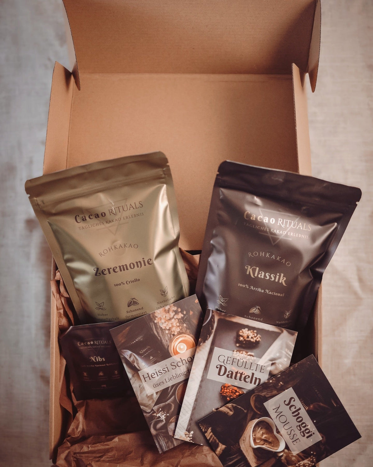 Starter Set Geschenkbox geöffnet mit Rohkakao und Rezeptkarten